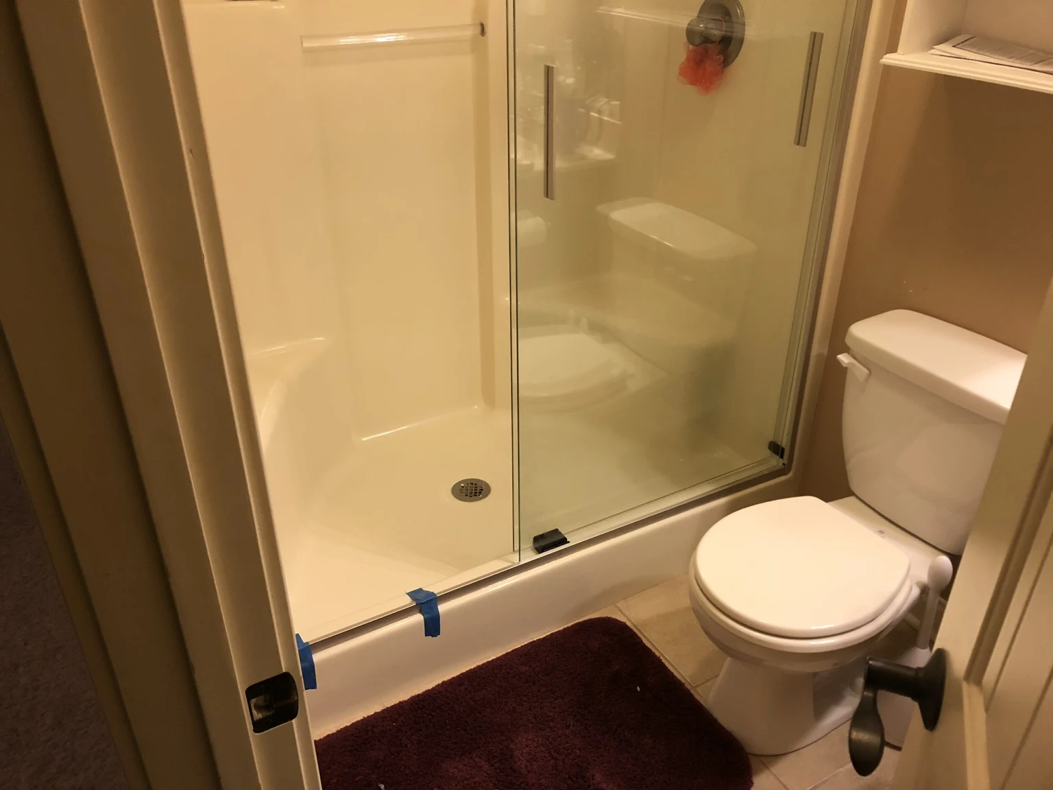 Sliding glass shower doors with a white surround